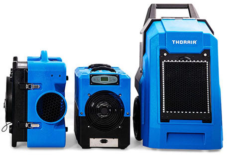 Blue professional equipment set for water damage restoration including air movers and dehumidifier